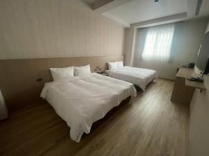 Postel nebo postele na pokoji v ubytování 星雨行館 Hotel