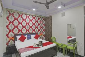 a bedroom with a bed and a dining room at Hotel O Metro Inn in Noida +35 photos