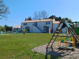 a playground in a yard with a house at Maison familiale avec babyfoot et piscine chauffée - FR-1-426-597 in Soullans