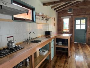 a kitchen with a sink and a counter top at Cabañas - Casa Rural 32 in Villa O'Higgins +8 photos