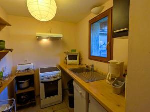 a kitchen with a sink and a counter top at Charmant T2 au centre avec parking et WIFI - FR-1-342-340 in Arêches +1 photo