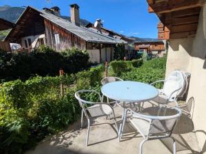 a table and chairs sitting on a patio at Charmant T2 au centre avec parking et WIFI - FR-1-342-340 in Arêches