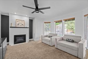 a living room with two couches and a fireplace at Lake, Hot Tub, Golf Retreat in Hayden Lake