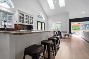 a kitchen with a bar with stools at Lake, Hot Tub, Golf Retreat in Hayden Lake