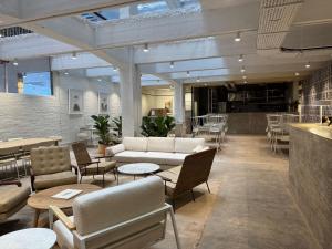 a lobby with couches and tables and a bar at BlackBrick Gardens in Cape Town