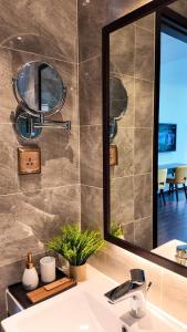 a bathroom with a sink and a mirror at Homestay Sapphire Studio với City View in Ha Long