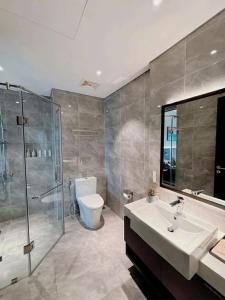 a bathroom with a sink and a shower and a toilet at Homestay Sapphire Studio với City View in Ha Long