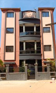 a large building with a clock on top of it at Residence Cabral in Guediawaye