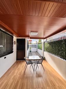 a room with a table and chairs on a balcony at RKs Cozy Balai in General Santos