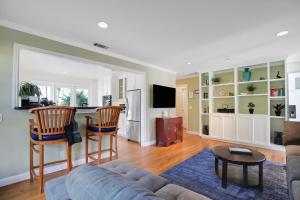 a living room with a couch and a table at Little Palm Cottage in Santa Barbara