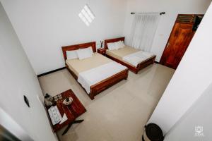 an overhead view of a bedroom with two beds at Lotus Udawalawe in Udawalawe