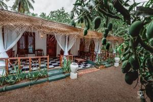 a house with a porch with a bunch of fruit at Lotus Udawalawe in Udawalawe