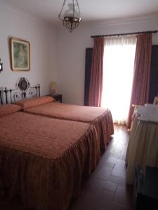 Postel nebo postele na pokoji v ubytování Hostal Gran Capitan