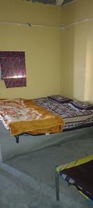 a bedroom with two beds and a window at Rann Roshni homestay in Bherandiāla