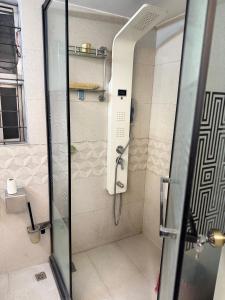 a shower with a glass door in a bathroom at Modern Luxury Escape Balcony & Family Friendly in Dhaka +17 photos