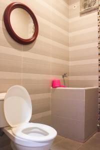 a bathroom with a toilet and a mirror and a tub at Omah Poer Modern Tropical Villa in Giri +47 photos