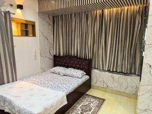 a bedroom with two beds and a window with curtains at Modern Luxury Escape Balcony & Family Friendly in Dhaka