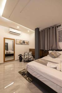a bedroom with a large bed and a mirror at The Cabyn in Accra