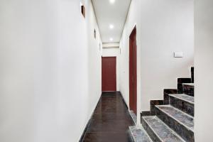 a corridor of a building with stairs and a red door at Collection O Sector 33 Gurgaon in Gurgaon