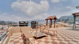 a deck with a playground on the roof at Coolspot Cottage in Ooty