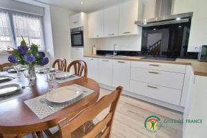 a kitchen and dining room with a table and chairs at Gite de kermativan in La Trinité-Surzur