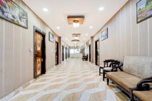 a hallway with couches and chairs in a building at Super Townhouse ESIC Medical College Faridabad Formerly Royal Mountain in Faridabad
