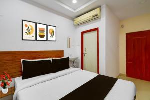 a bedroom with a bed and a red door at Super Collection O L.B Nagar Metro Station Formerly D N Groups in Surūrnagar