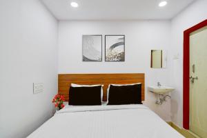 a bedroom with a large bed and a sink at Super Collection O L.B Nagar Metro Station Formerly D N Groups in Surūrnagar