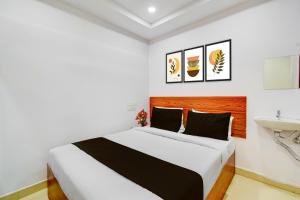 a bedroom with a large bed and a sink at Super Collection O L.B Nagar Metro Station Formerly D N Groups in Surūrnagar