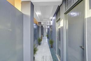 a hallway of an office with potted plants at Hotel O Metro Inn in Noida