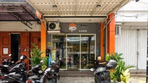 a group of motorcycles parked in front of a store at The Cabin Tanjung Yogyakarta in Yogyakarta