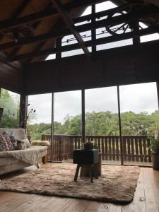 a living room with a couch and a large window at Cabana Gehrke in Nova Petrópolis