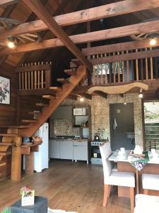 a kitchen and dining room with wooden ceilings at Cabana Gehrke in Nova Petrópolis