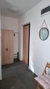 an empty room with a door and a mirror at Srebrno Jezero studio apartman Dimi in Veliko Gradište