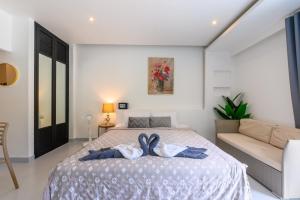 a bedroom with a bed and a couch at Sunny Blue Runway in Ban Nai Na +35 photos