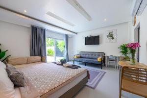 a living room with a bed and a couch at Sunny Blue Runway in Ban Nai Na