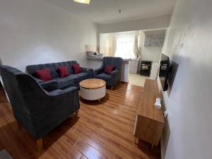 a living room with two couches and a table at Savannah Residence in Libwezi