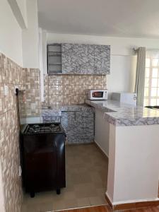 a kitchen with a stove and a counter top at Savannah Residence in Libwezi +12 photos