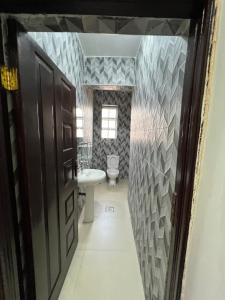 a bathroom with a sink and a toilet in it at Savannah Residence in Libwezi