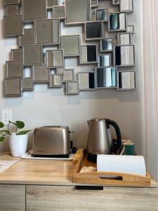 a collage of pictures on a wall above a kitchen counter at Marina Front Qbed Ensuite Room For Dog Lovers SOLE traveler only in Shellharbour