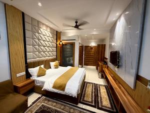 a hotel room with a bed and a couch at The Grand's in Jagādhri