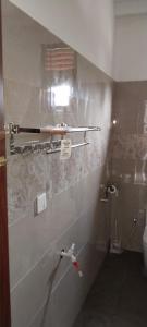 a bathroom with a toilet and a towel rack at Ariyana Sky Suites in Matara +62 photos