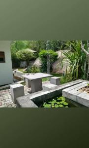 a park with a picnic table and a pond at Elephant View Hotel in Damana +2 photos