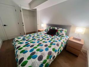 a bedroom with a bed with a colorful comforter at Kris Anclam in Langley