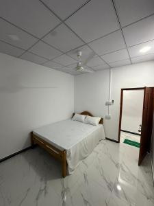 a bedroom with a bed and a mirror in it at Trikon Villaa in Trincomalee