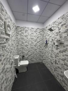 a bathroom with a shower and a toilet and a sink at Trikon Villaa in Trincomalee