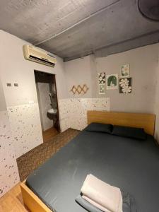 a bedroom with a large bed and a bathroom at Ubuntu Central Stay 57 Hang Be in Hanoi