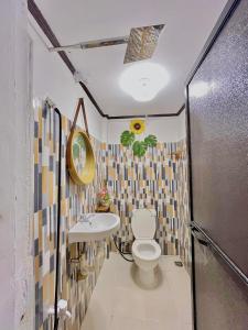 a bathroom with a toilet and a sink at Precious Homestay - Serenity Room in Burgos
