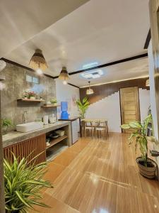 a kitchen and dining room with wooden floors and plants at Precious Homestay - Serenity Room in Burgos