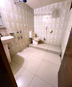 a bathroom with a toilet and a sink at W Hotel Sylhet in Sylhet +16 photos